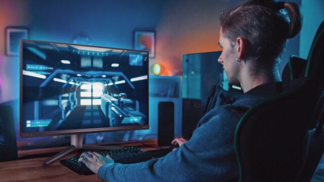 Back,Shot,Of,A,Gamer,Playing,First-person,Shooter,Online,Video